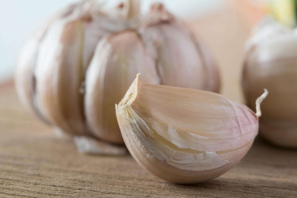 Fresh garlic cloves on wooden board – gut friendly foods